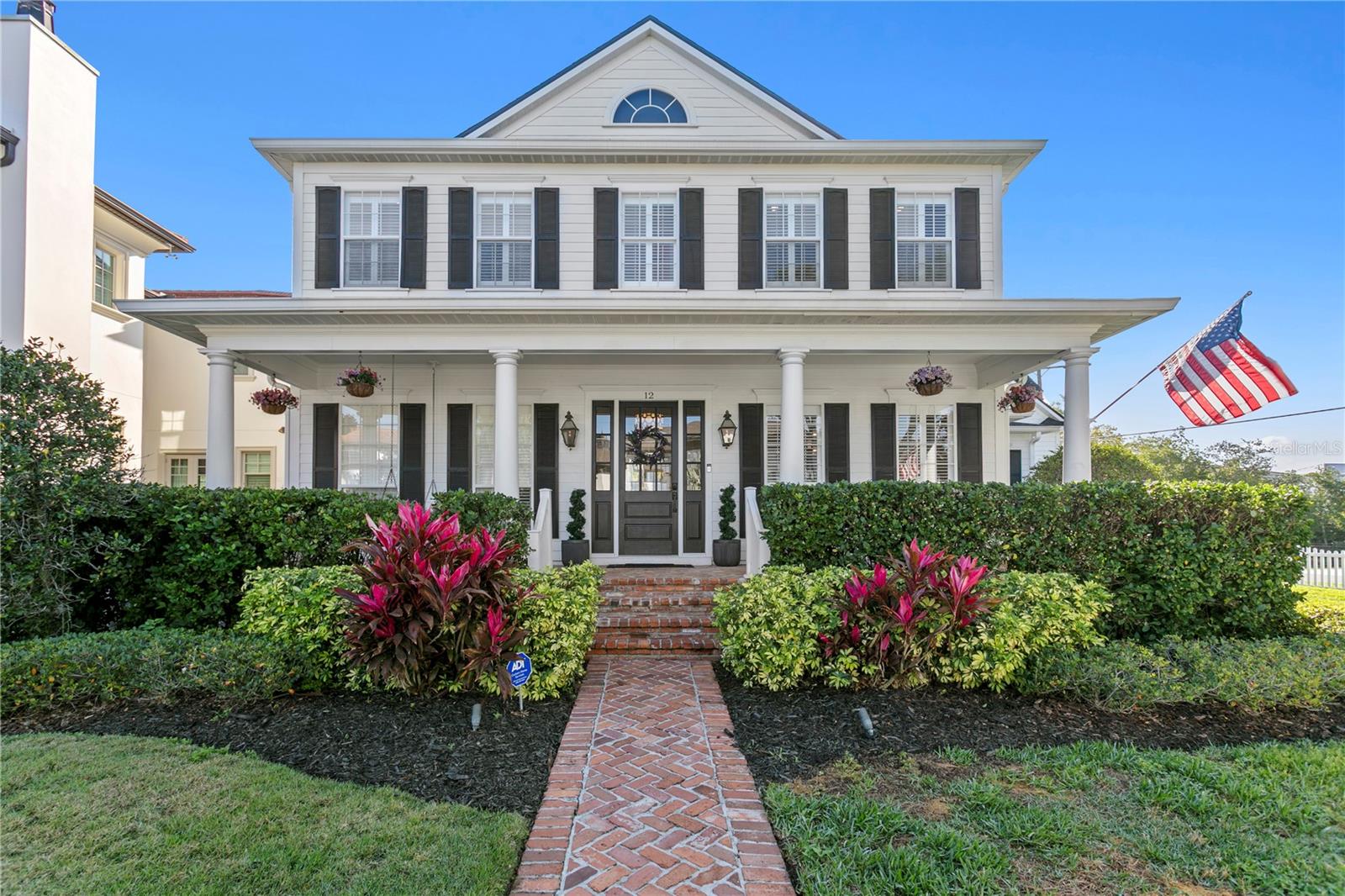 Beautiful corner lot with brick walk leading to the home and bricked front and back porches