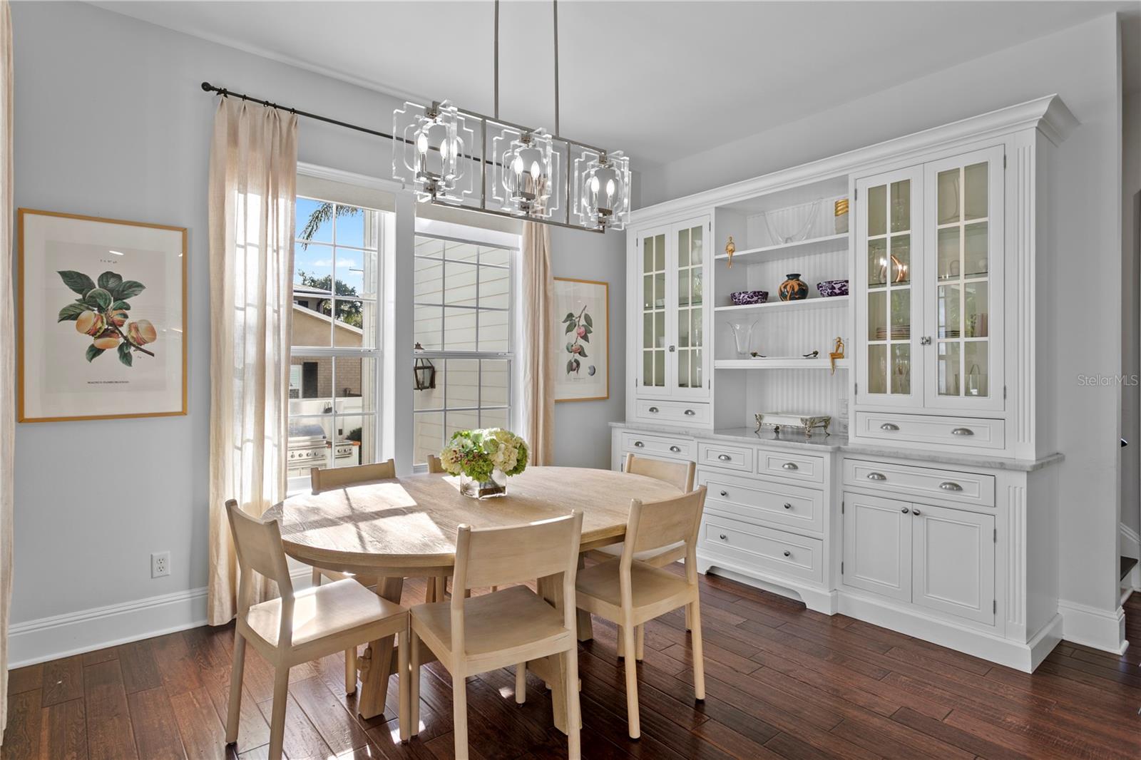The informal dining area also enjoys gorgeous custom blt cabinets for storage