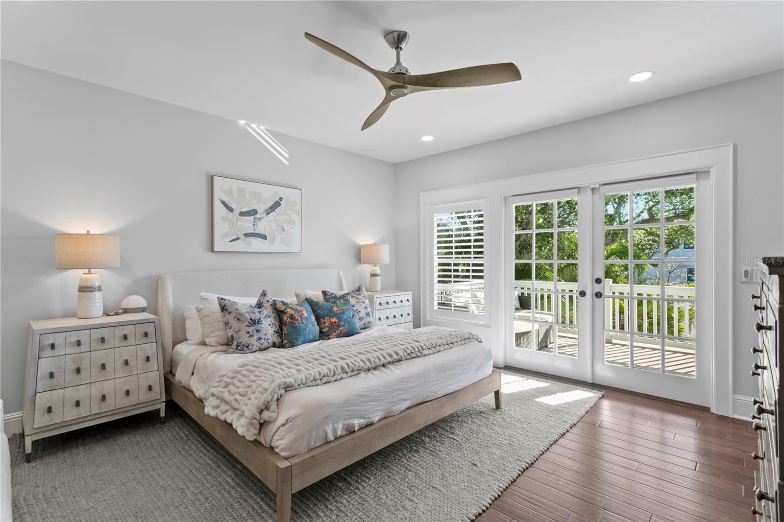 The primary bedroom has beautiful French doors to a private balcony for relaxing mornings and evenings