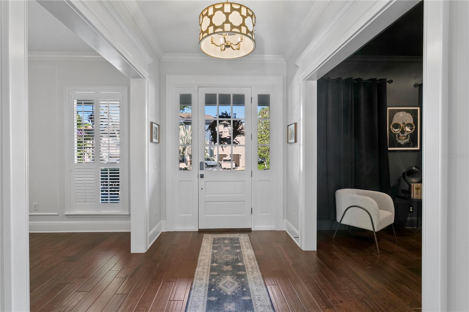 Center Hallway Foyer with high ceilings welcomes you into the home