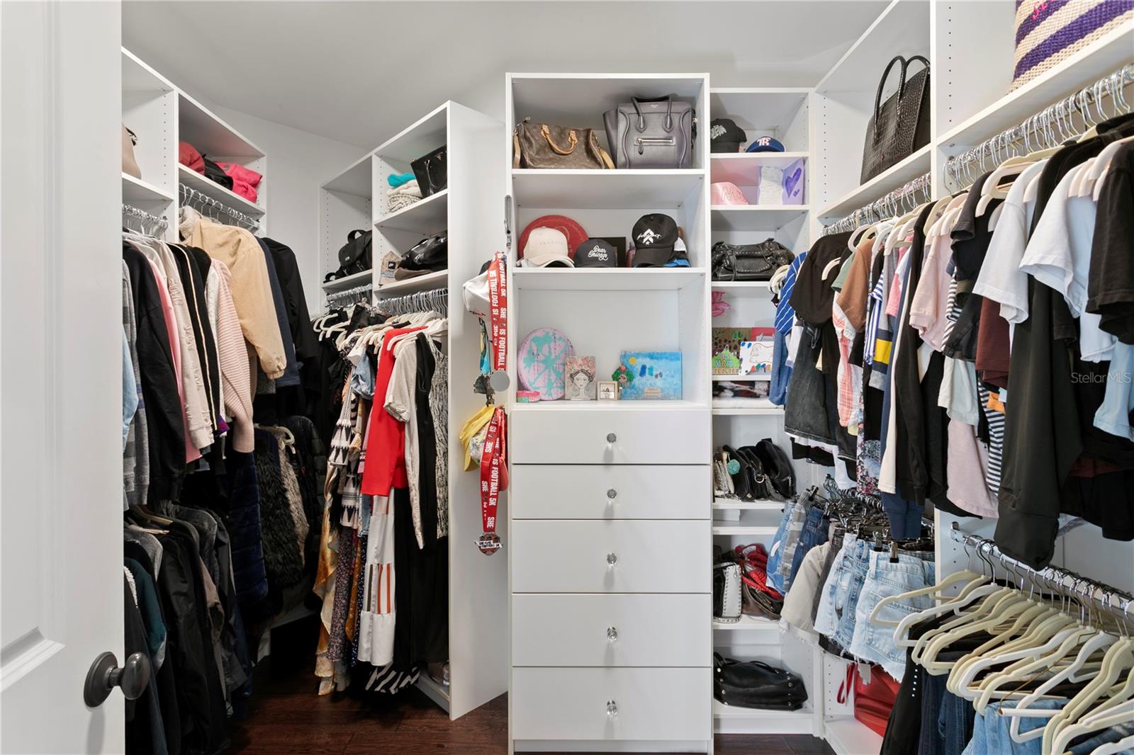 Spacious closet space organized with custom organizers