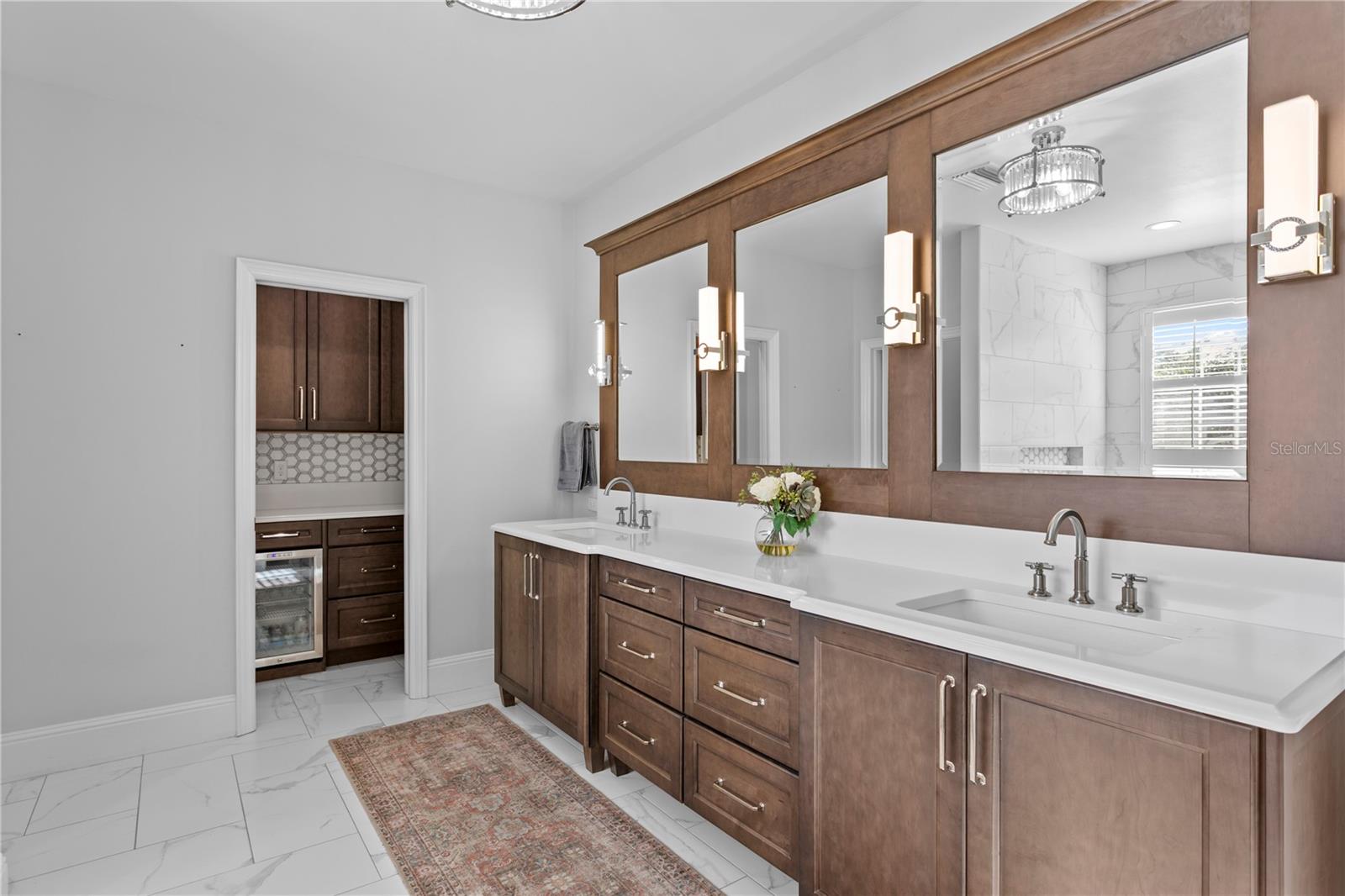 Notice the separate beverage refrigerator and coffee bar -- steps from your primary bedroom