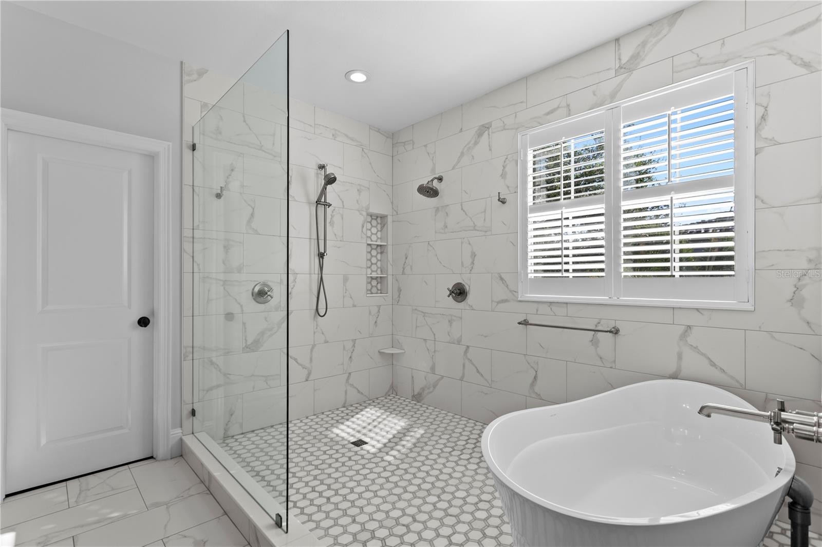 This gorgeous wet room includes deep soaking tub and oversized shower space