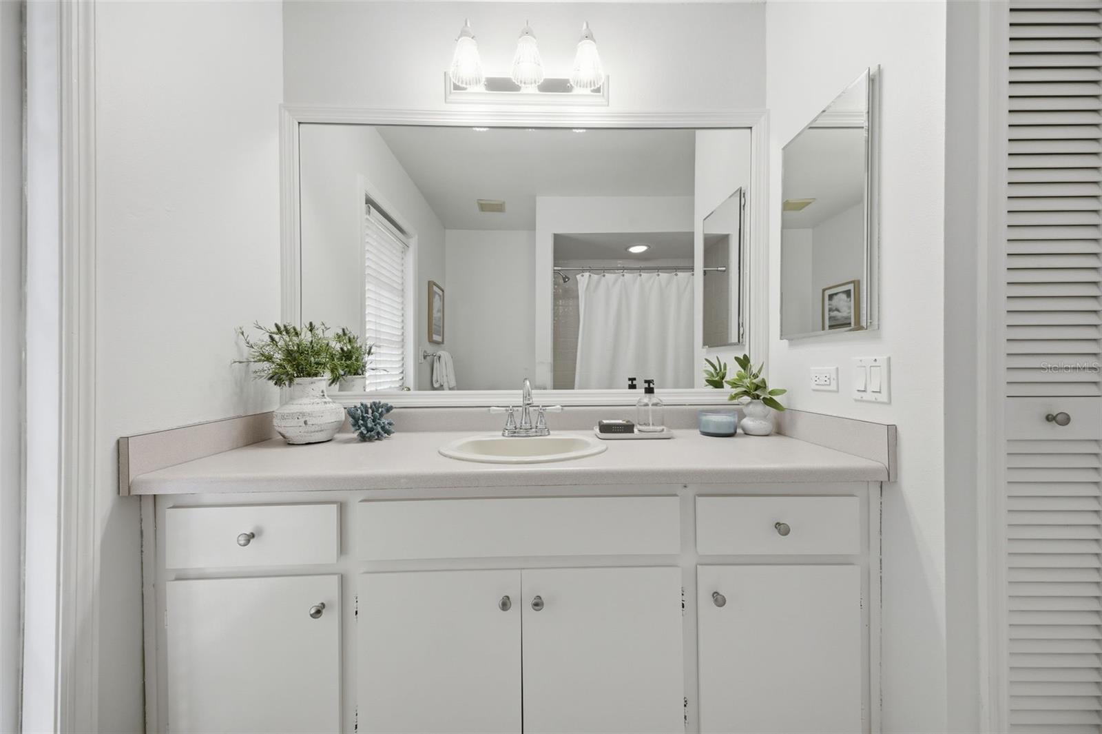 Second bathroom features a linen closet