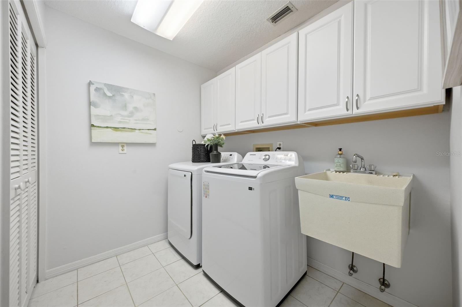 Indoor laundry with utility sink & closet space