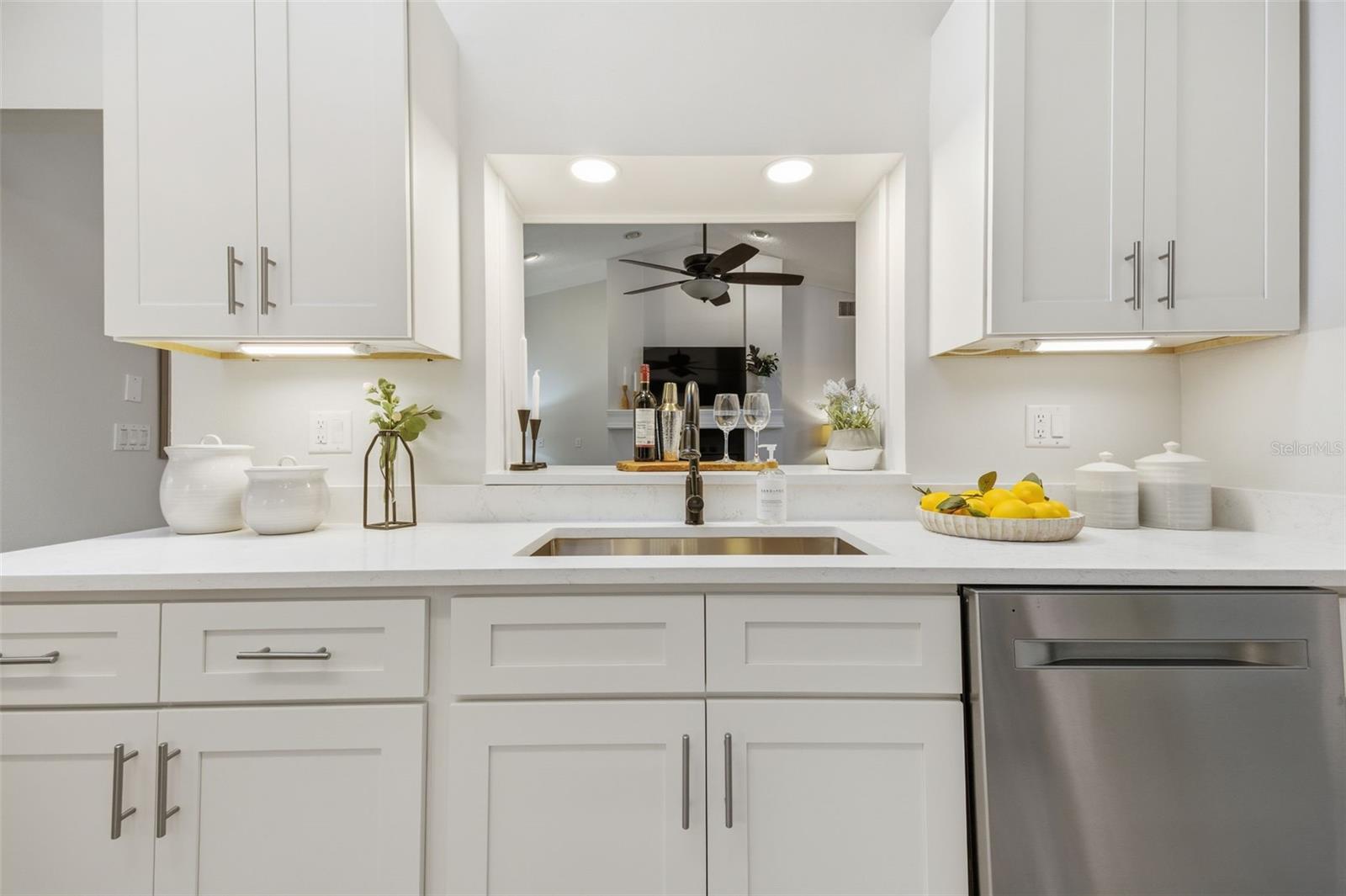 Single basin undermount stainless steel sink with breakfast bar to family room