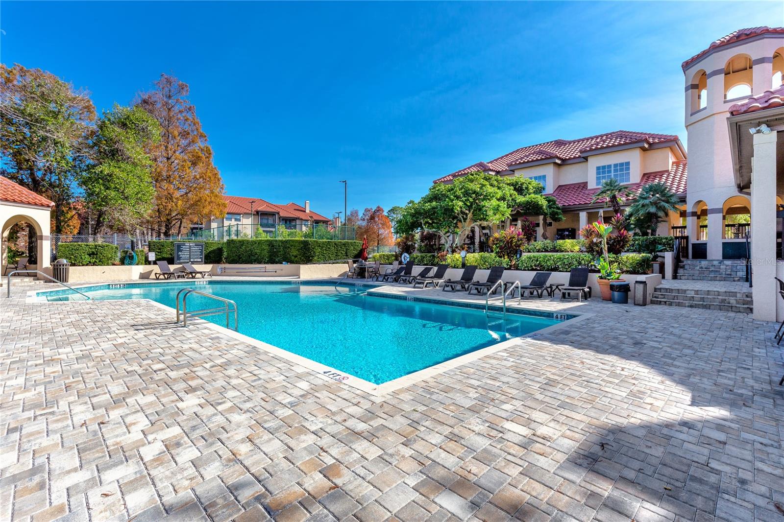 Heated pool and view of the recreational facilities building