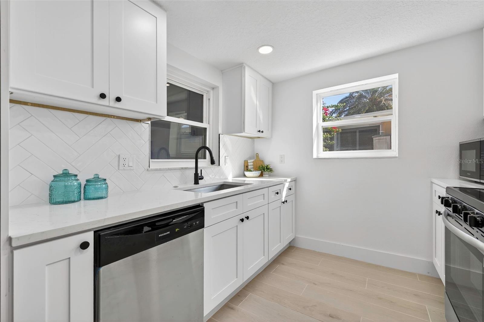 Modern kitchen with shaker cabinetry and stainless appliances
