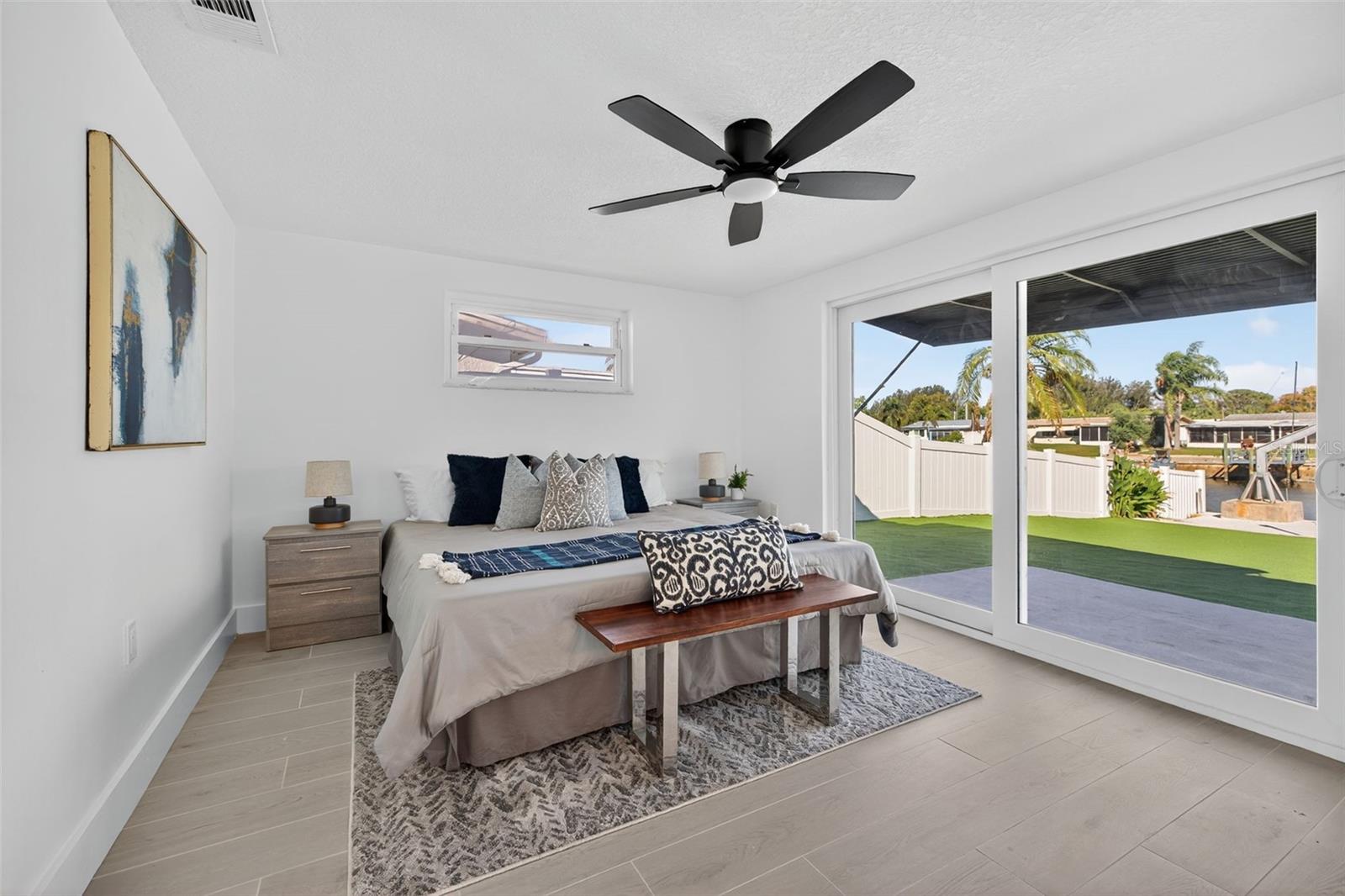 Spacious primary bedroom with water views
