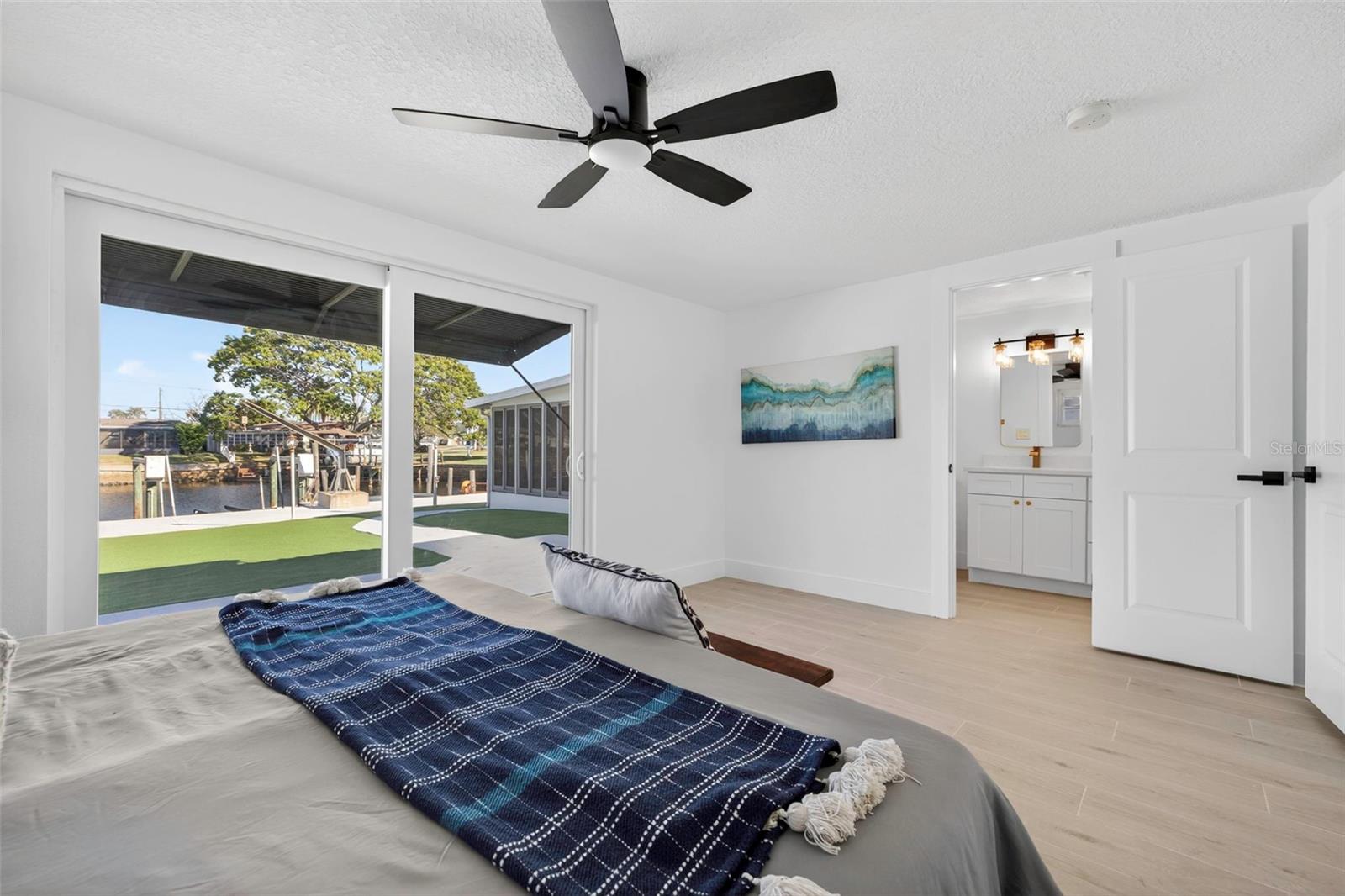 Primary bedroom with natural light and canal views