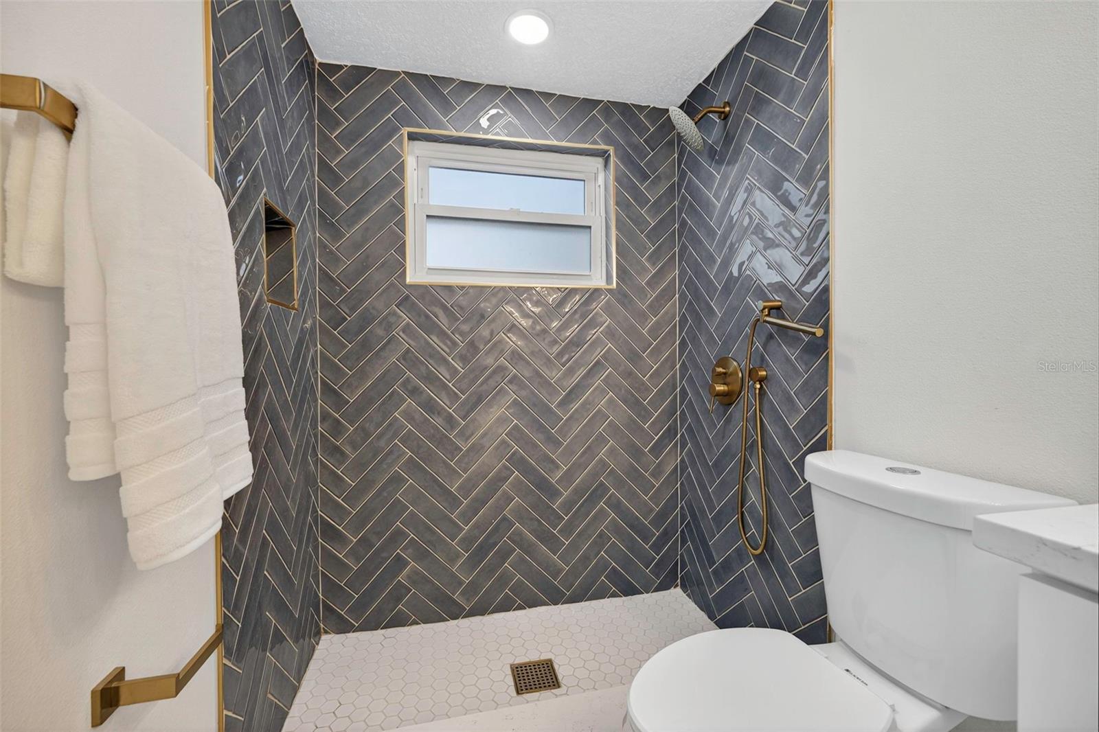 Spacious primary bedroom with water views