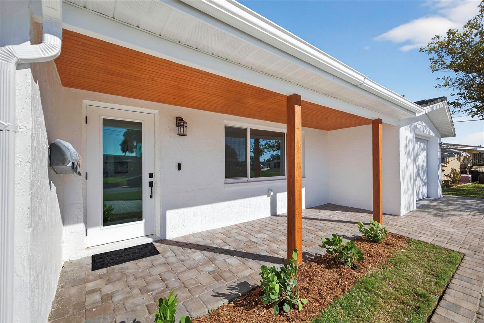 Front porch featuring a stained wood ceiling and custom artist-designed mailbox