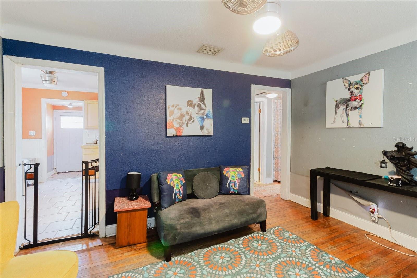 Living Room With Doorway on Left Goes To the Kitchen, Doorway on Right Goes To The Bedrooms and the Bathroom
