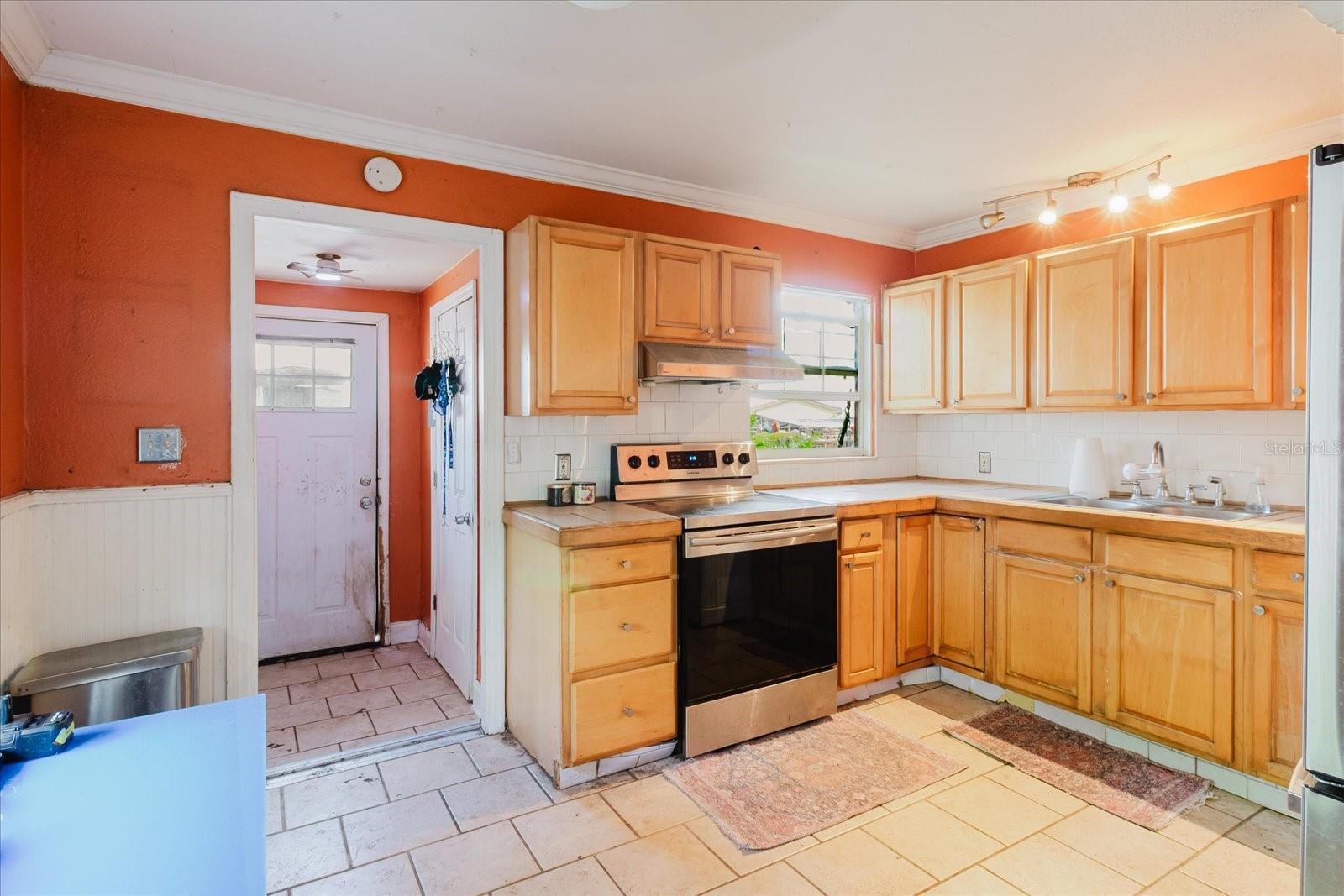 Kitchen with Doorway That Goes to the Laundry Room and Back Door to the Fenced In Back Yard
