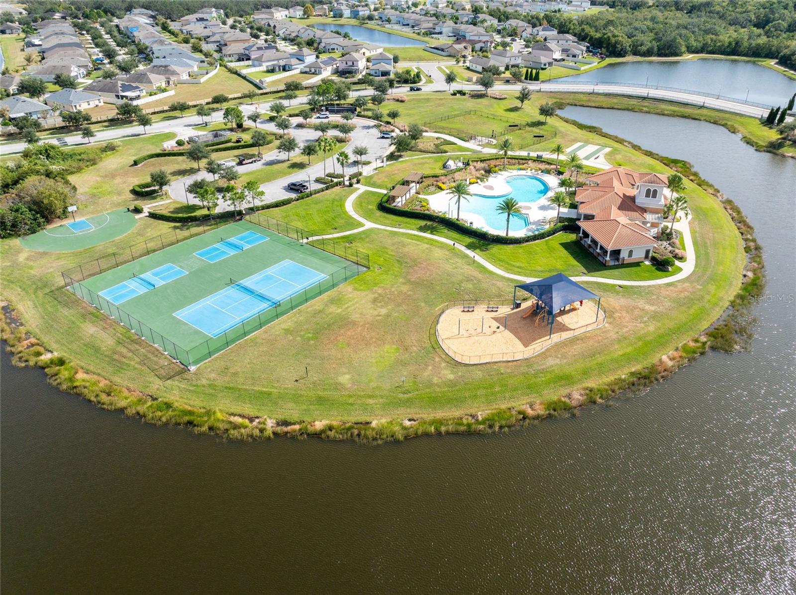 Resort-style amenities including a sparkling pool, clubhouse, fitness center, pickleball and tennis courts, basketball court and scenic walking trails.