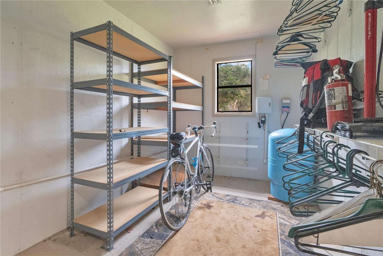 Storage area inside workshop/detached garage. Pressure tank for well is in here.