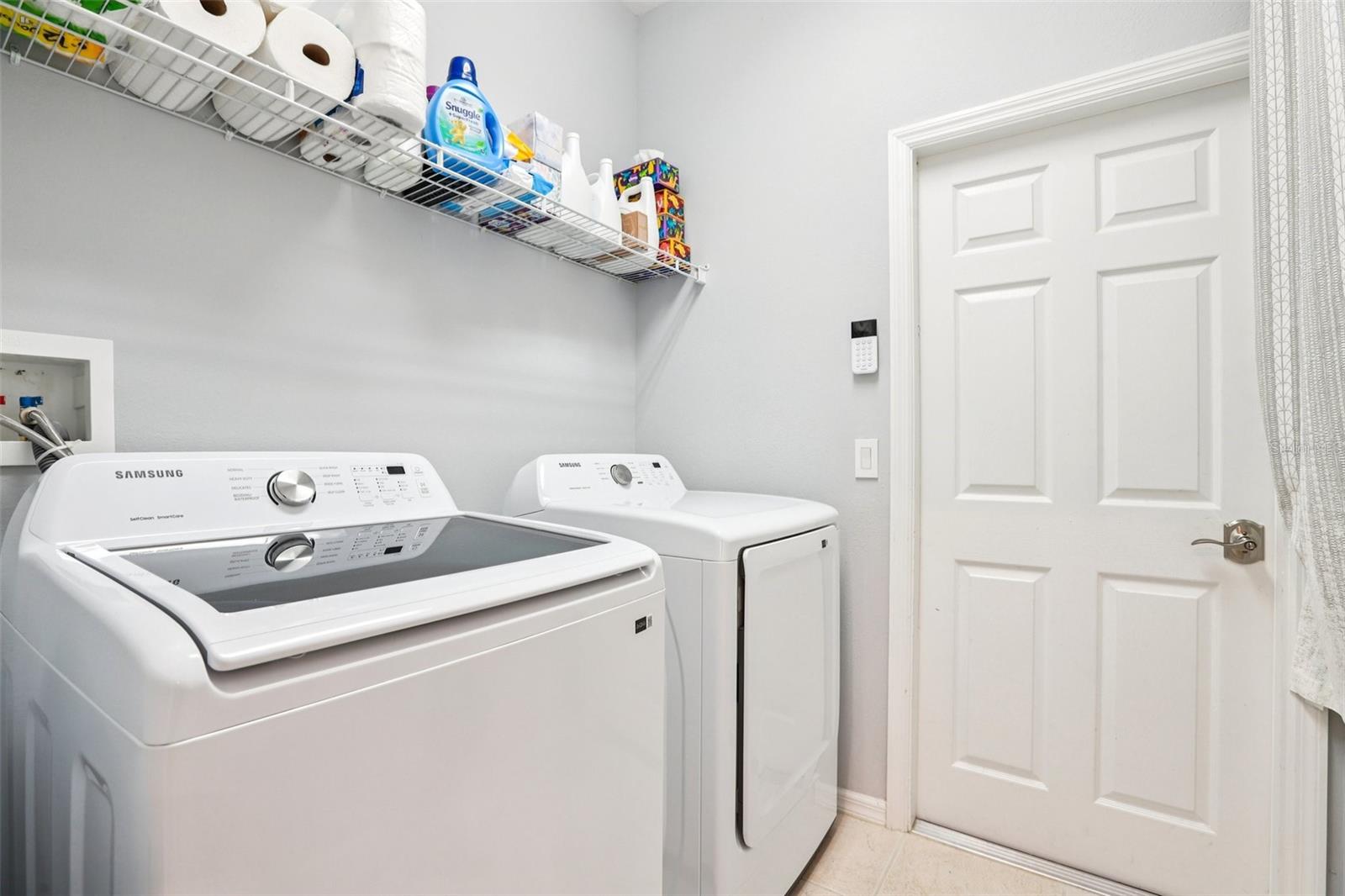 Laundry room with shelving and cabinets