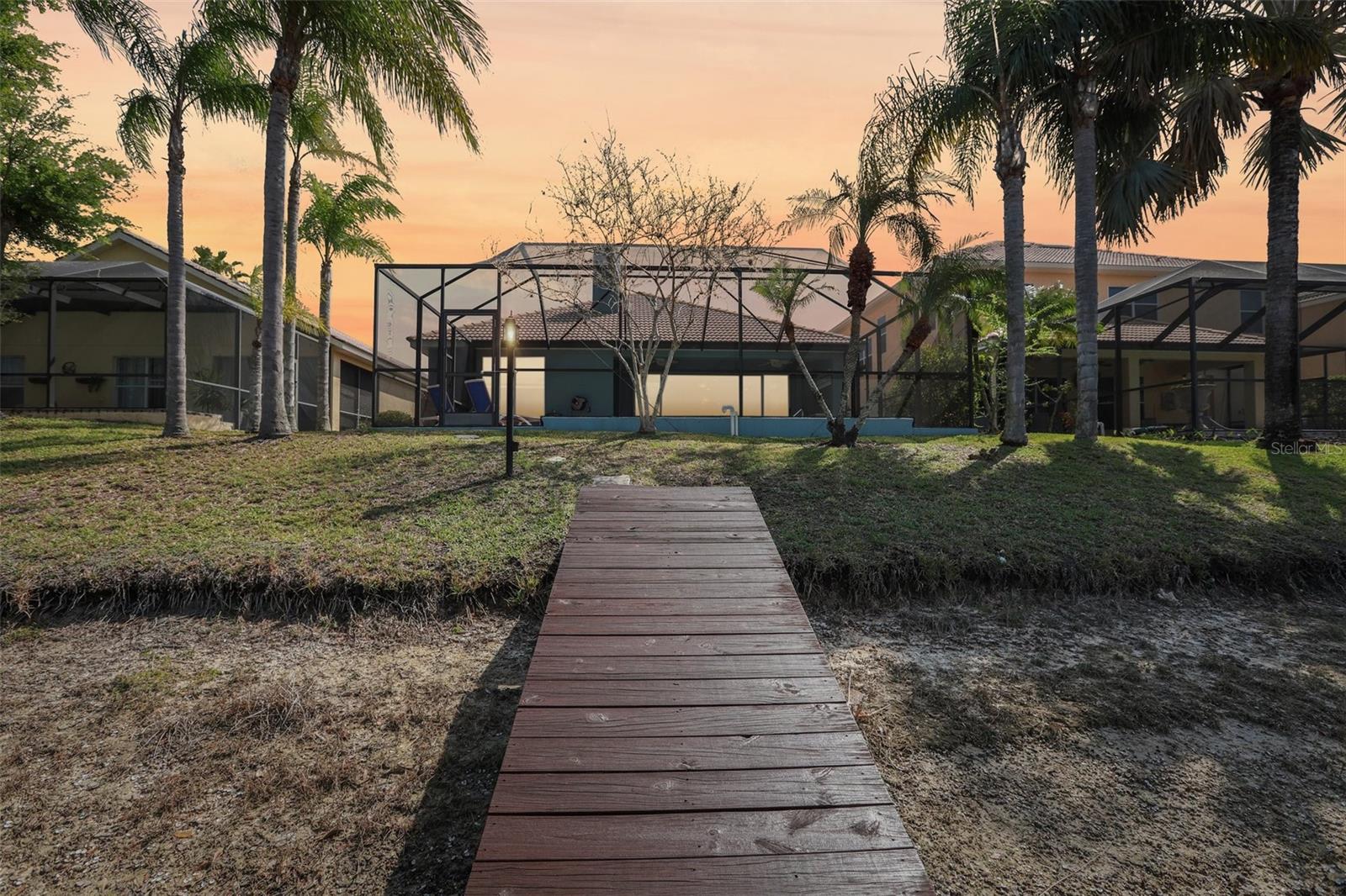 Rear view of home from dock, virtual twilight