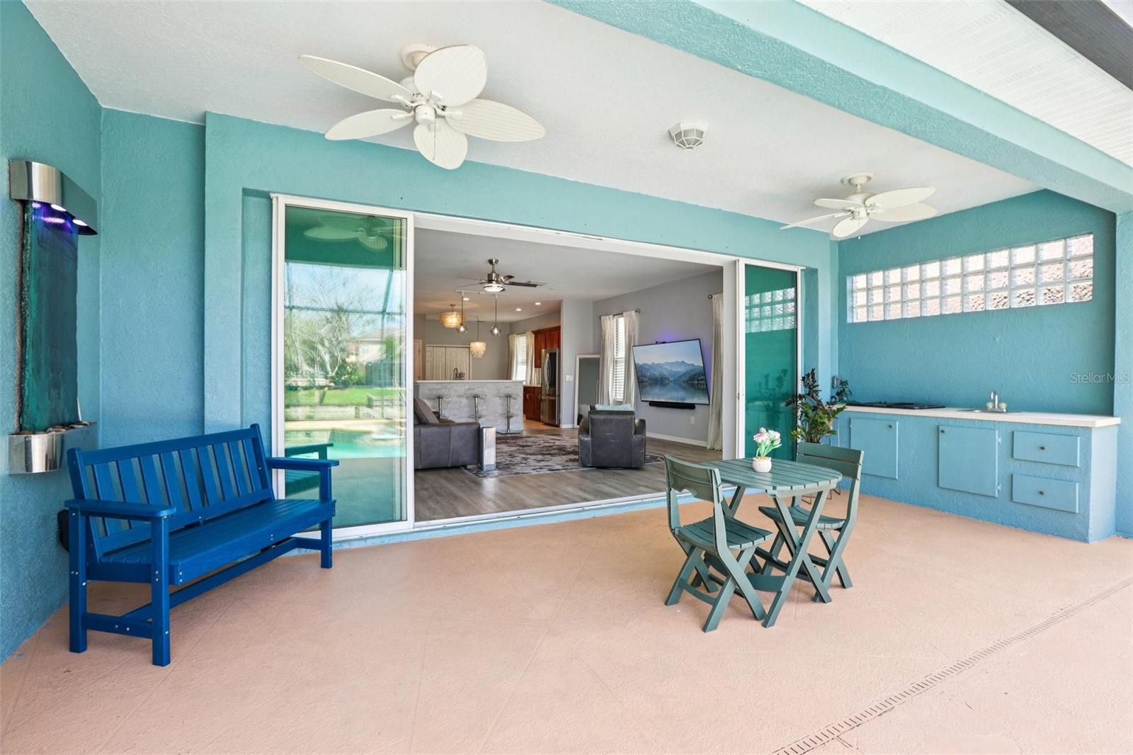 Enjoy a view of pool and lake with wall-mounted water feature