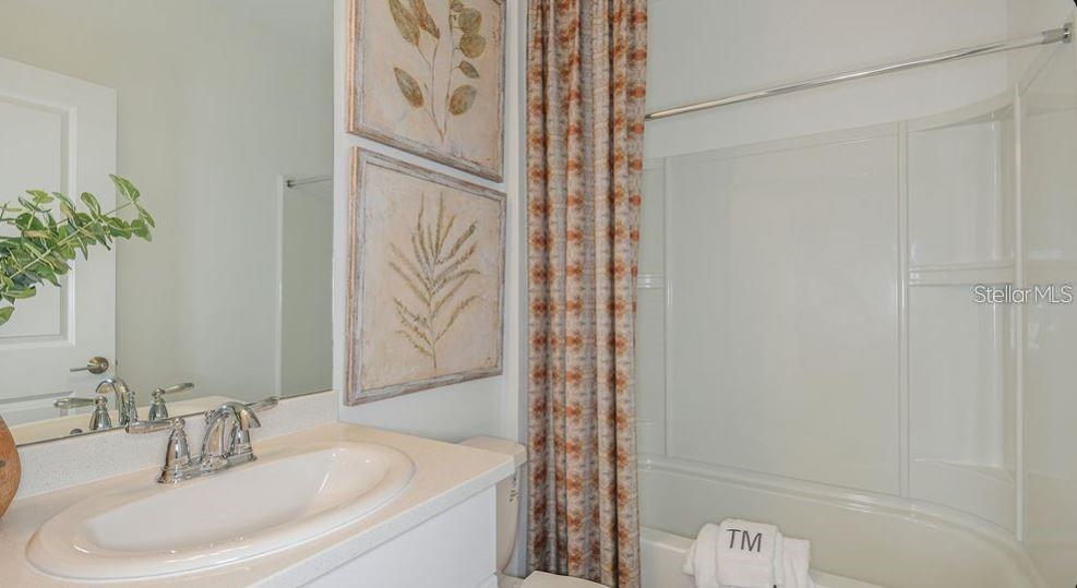 Guest bathroom has tub/shower combination
