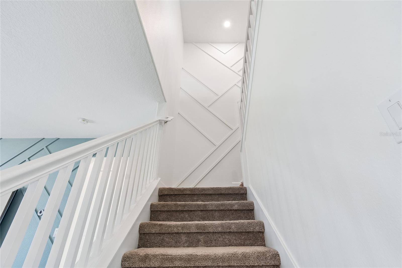 Stairs to upper level w/ accent wall