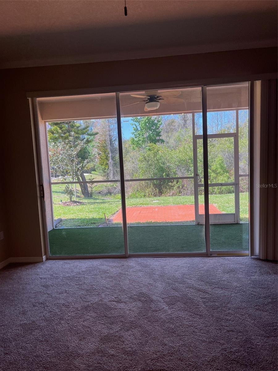 LIVING ROOM WITH VIEW OUT TO SCREENED PATIO