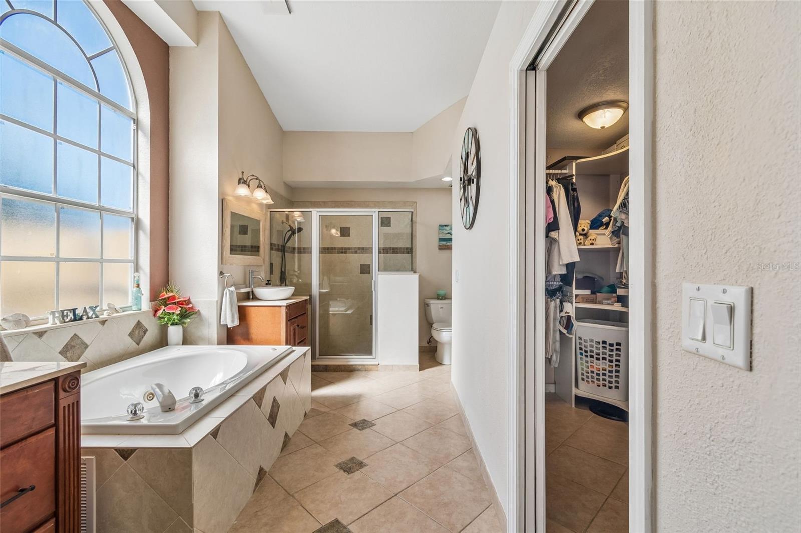 Split vanities, soaking tub, separate shower and large walk-in closet complete the ensuite bath.