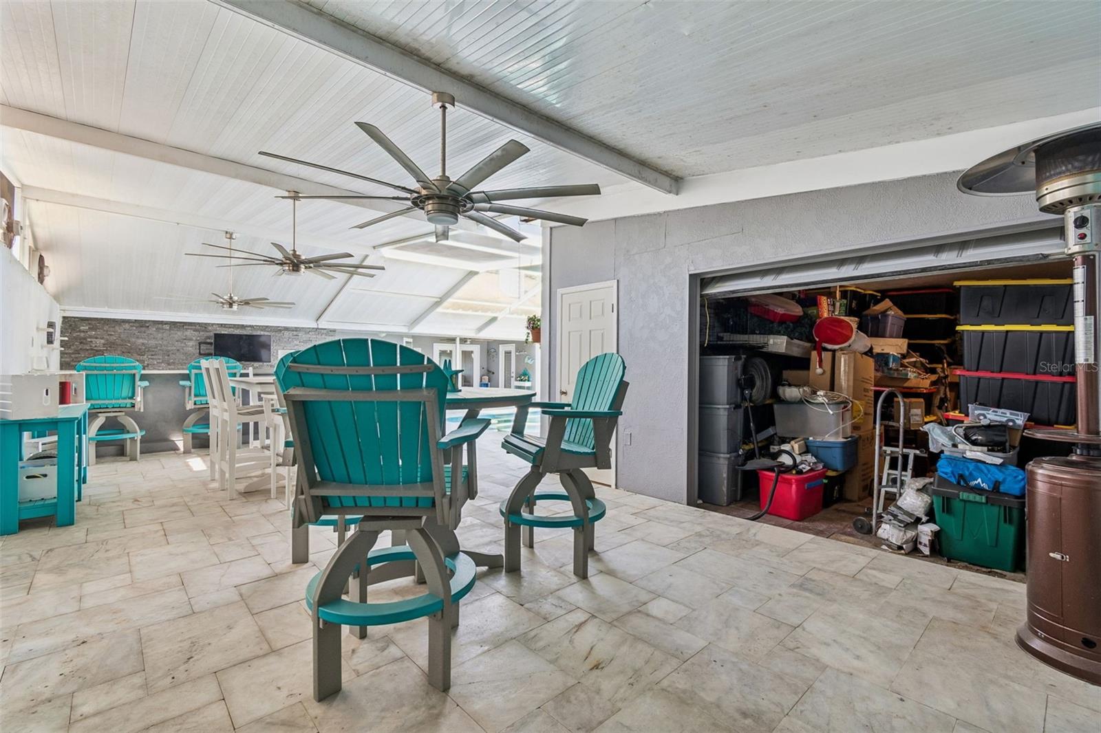 Off one of the eating areas, behind a garage door, lies a great storage room for all your toys! The door on the left leads to a pool supply room for all your floats, chemicals, etc...