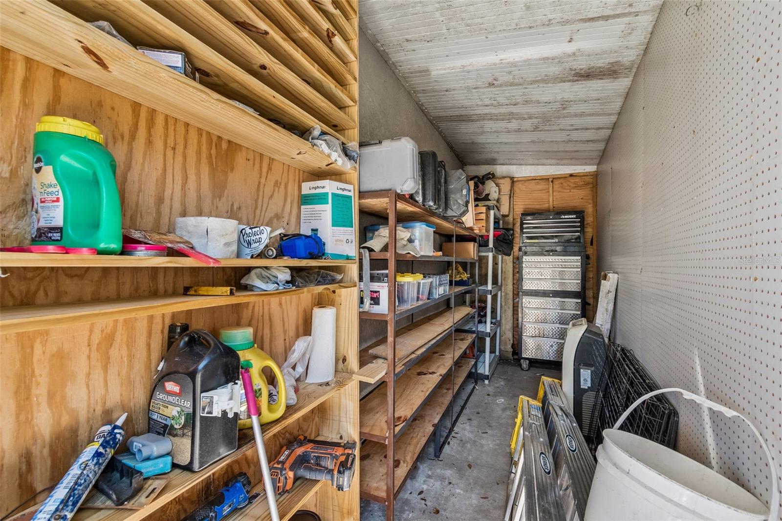 Tool strorge room at rear of home beside the open area workshop area!