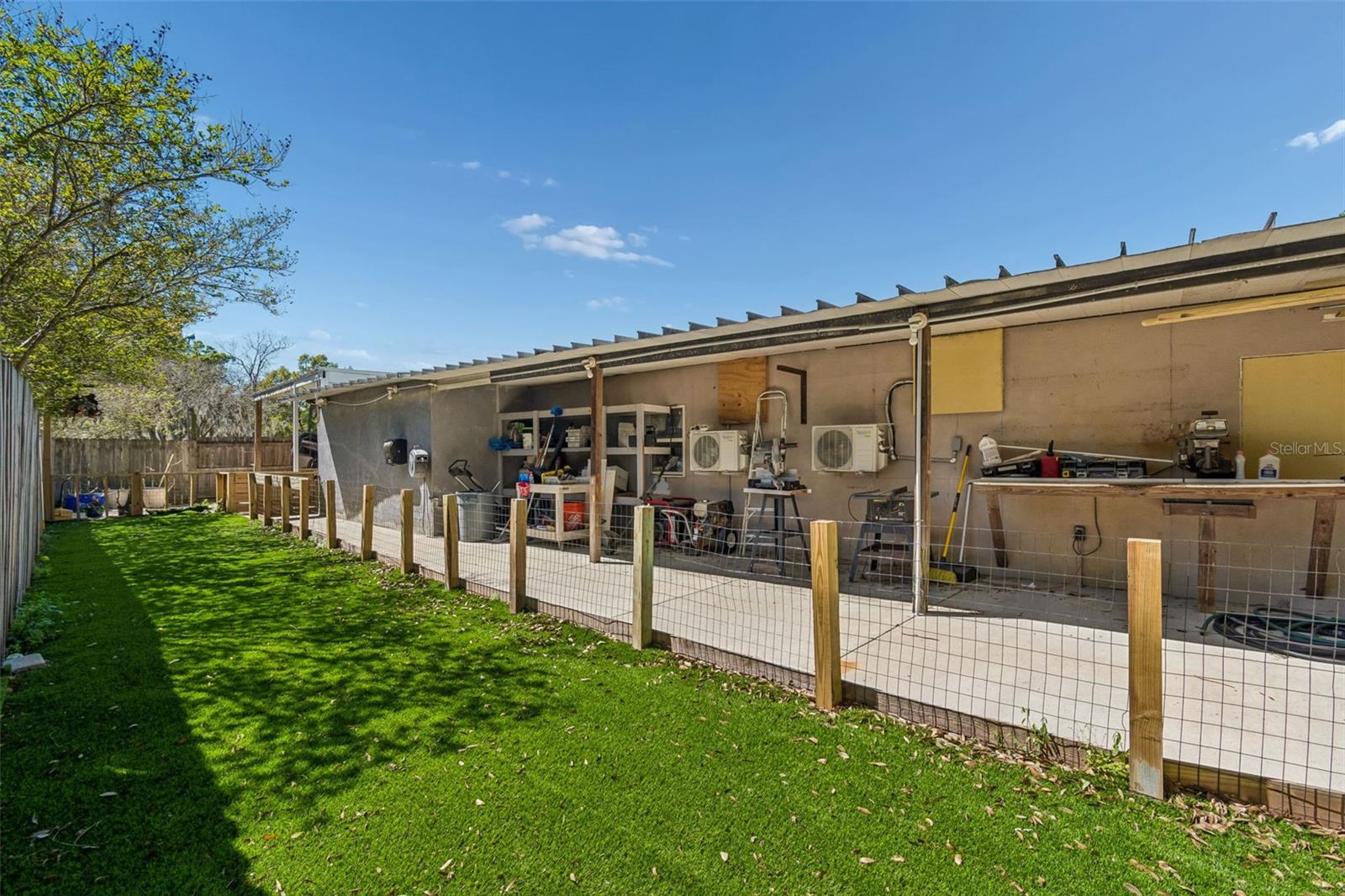 Calling all handymen...this workshop is perfect for home projects! There is a closet around the corner for all your tools.The green area is presently used as a dog run, but may be converted to a putting green.