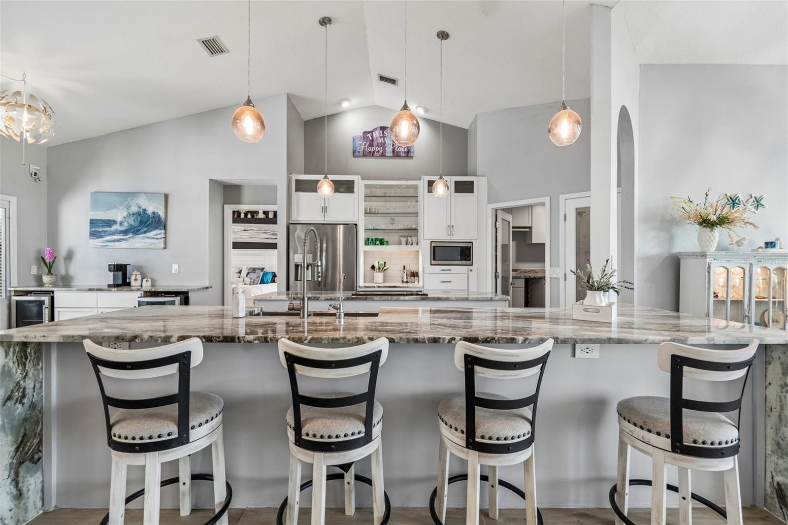 Open kitchen with 2 islands...one housing the range for cooking and the other for your sink and breakfast counter bar.