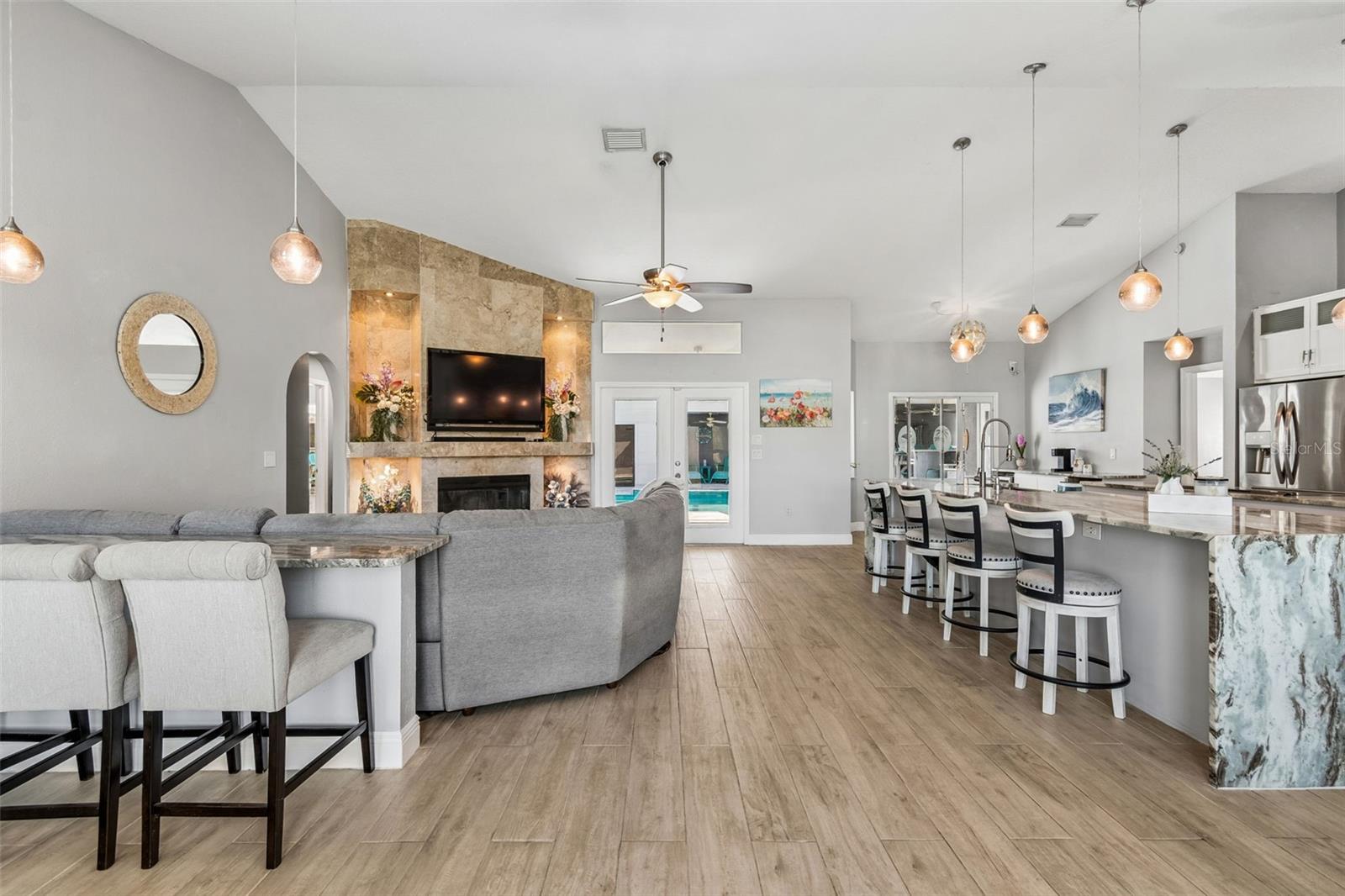 From the front door, you catch a glimpse of the open family room with ANOTHER eating bar to the left...this house is definitely for entertaining a crowd!