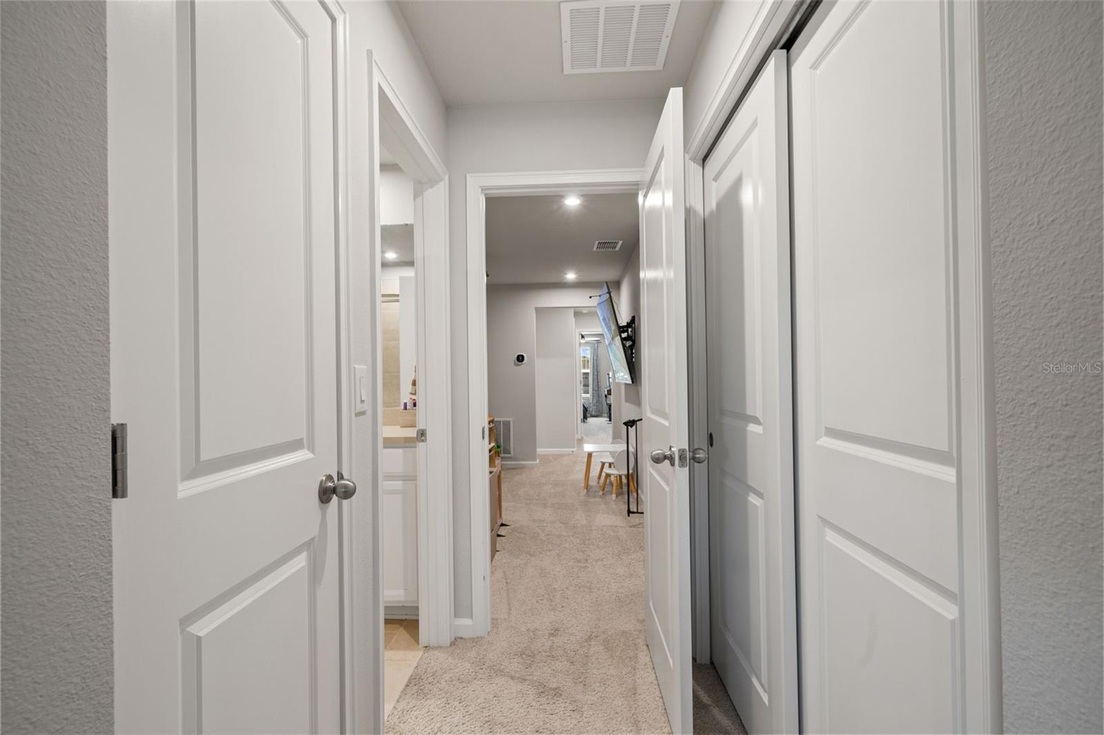 Owner's Bedroom entry with linen closet and storage closet