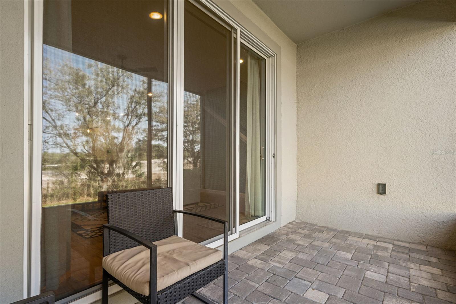 Triple glass sliders lead out to patio on first floor