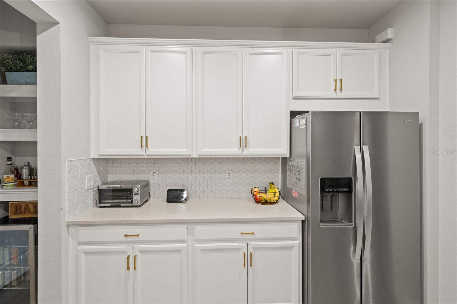 42' White Cabinets with recessed lighting throughout kitchen and living room