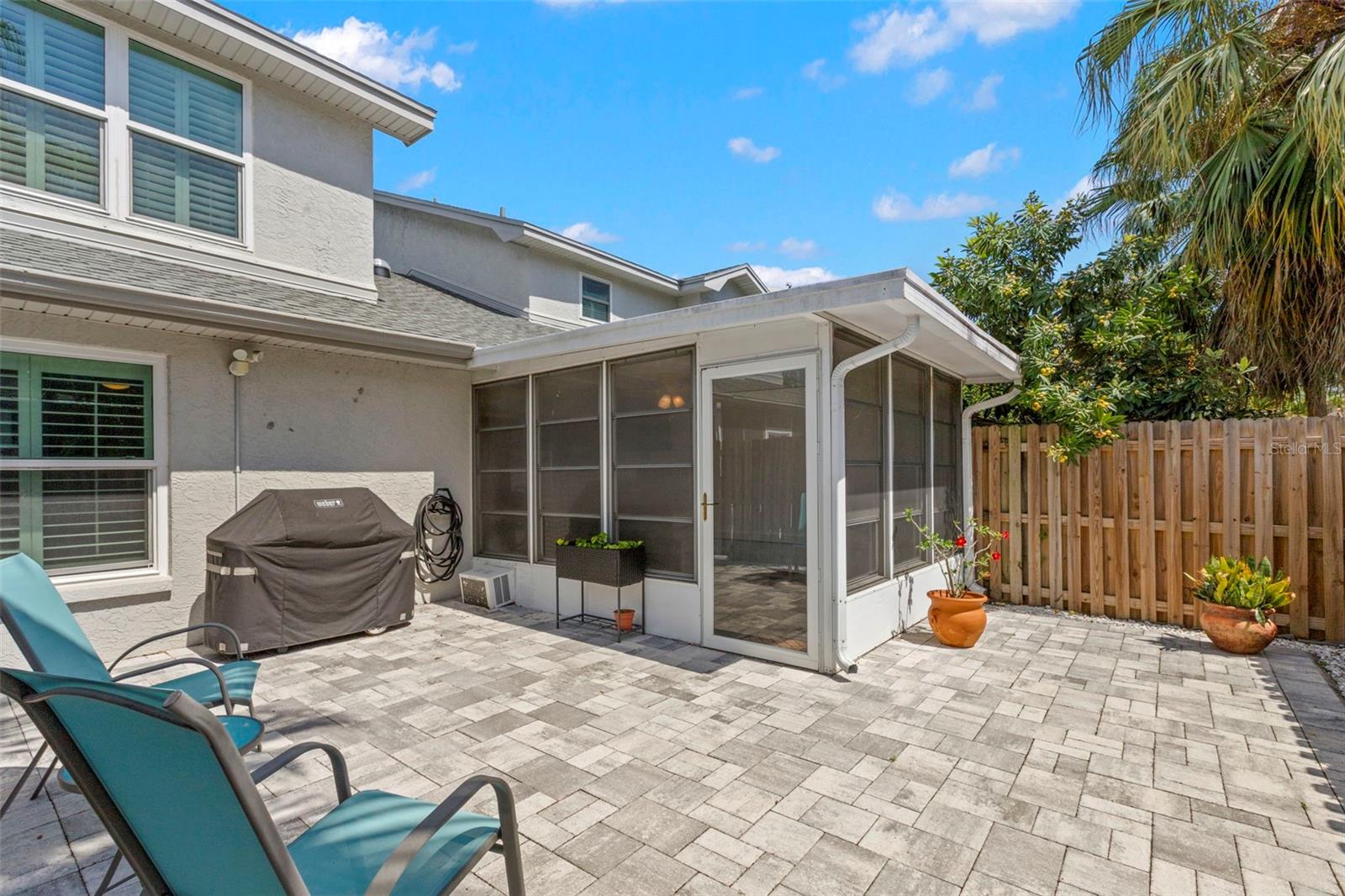 Fenced-in backyard with beautiful brick pavers