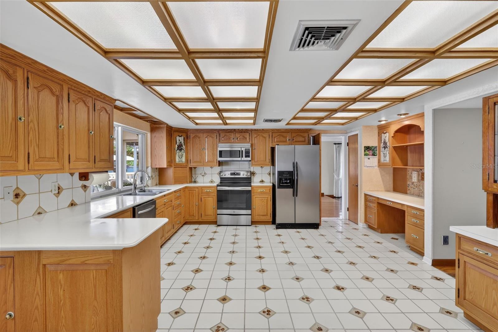 The kitchen is large and open,  with a view to the water, stainless steel appliances, lots of storage and a built in desk area.