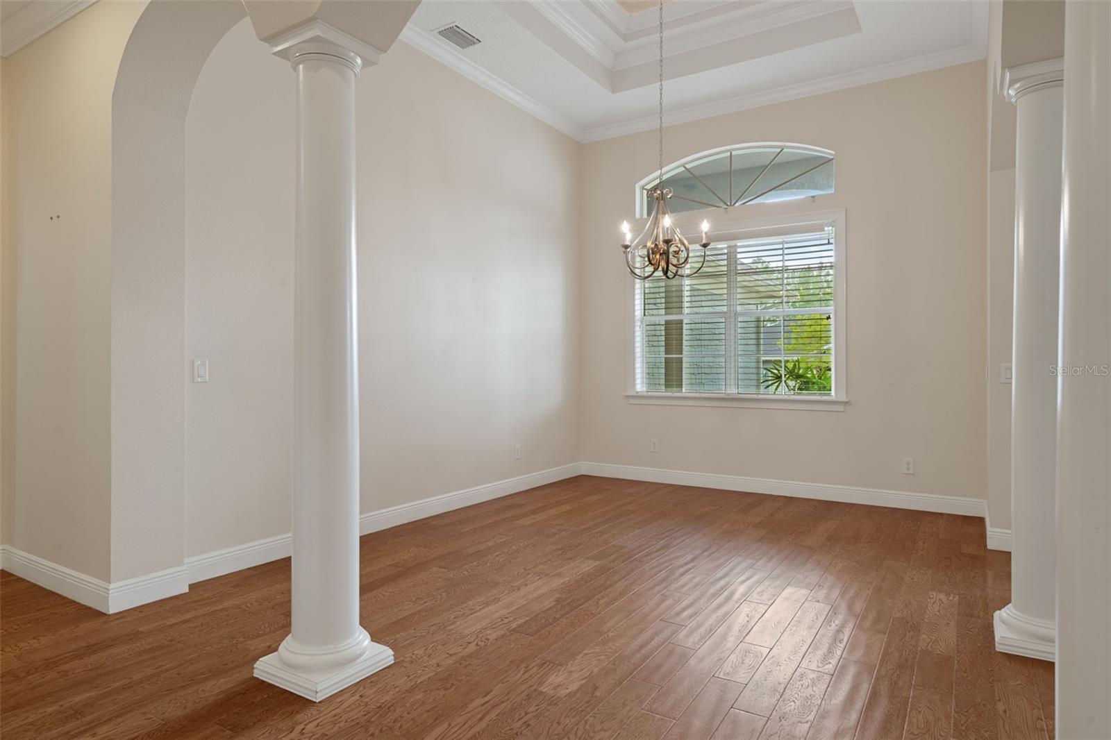 Dining Room with Double Tray Ceiling and Hardwood Floors