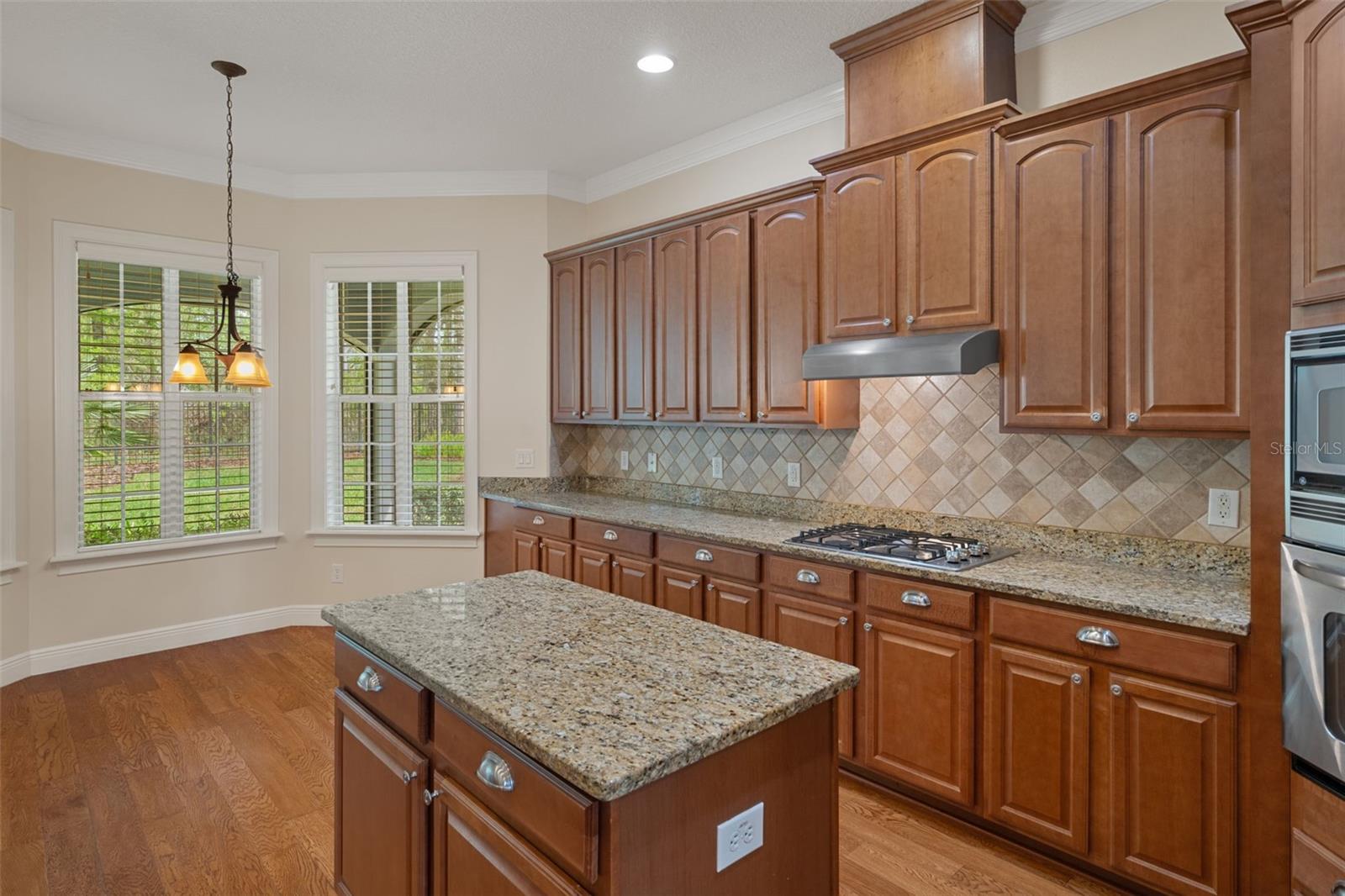 Kitchen with Granite Top Island and Cabinetry