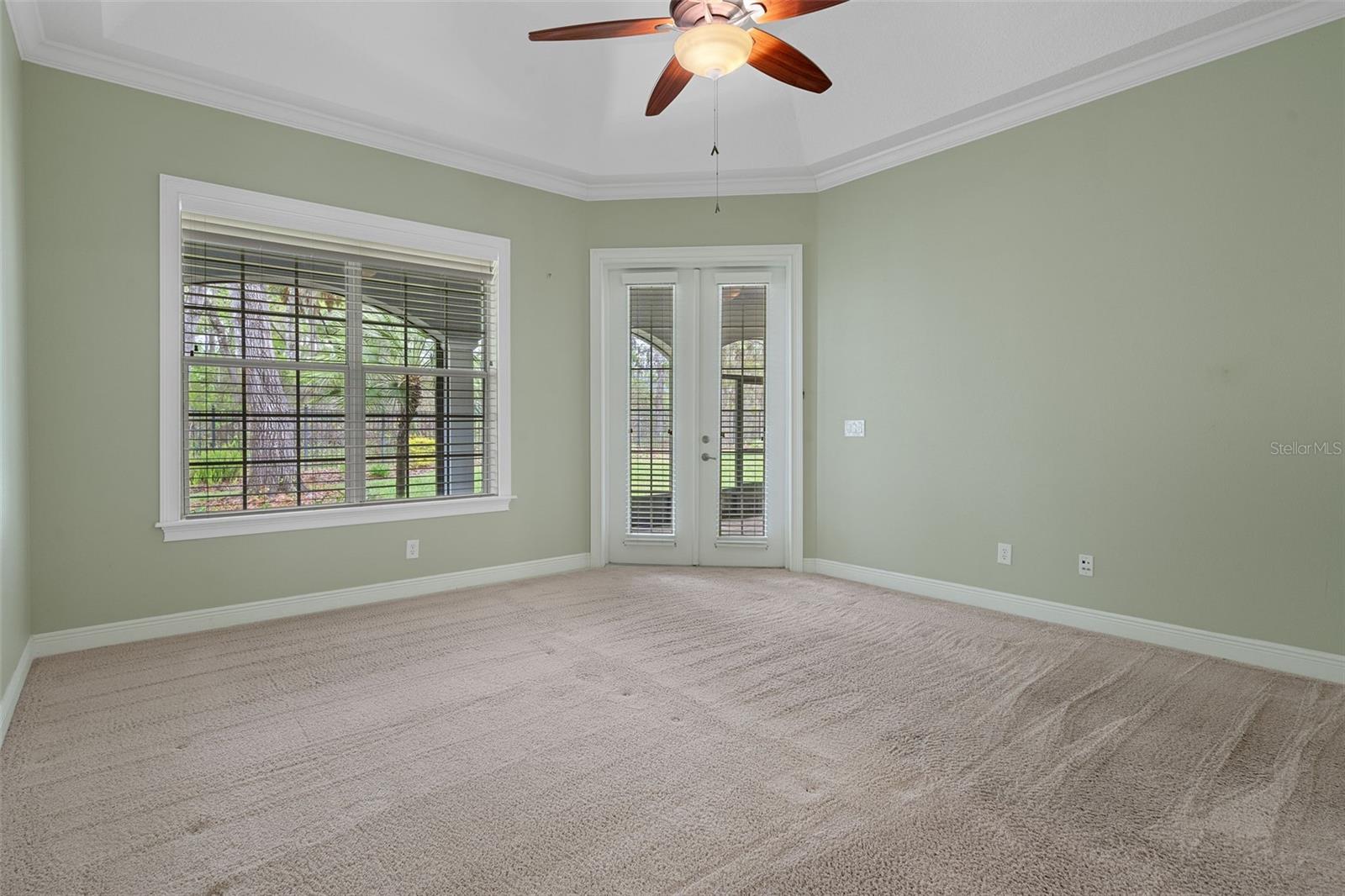 Primary Bedroom with French Doors to Covered Lanai