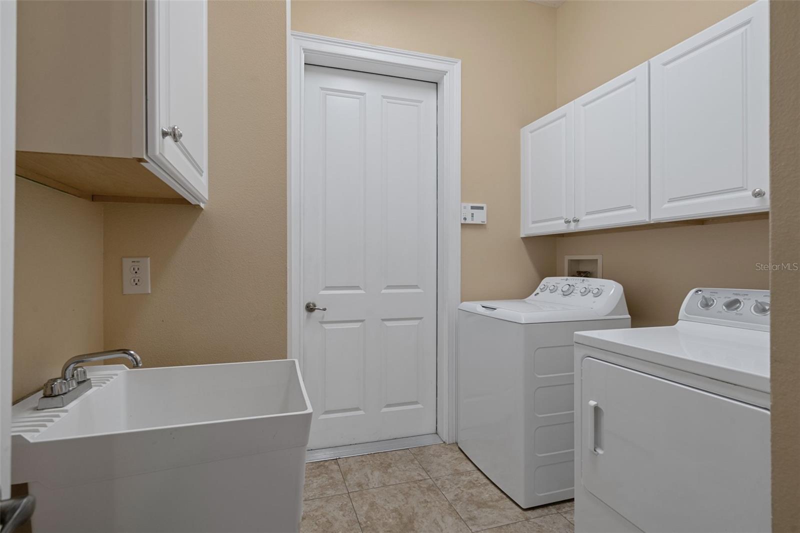 Laundry Room with Cabinetry and Sink