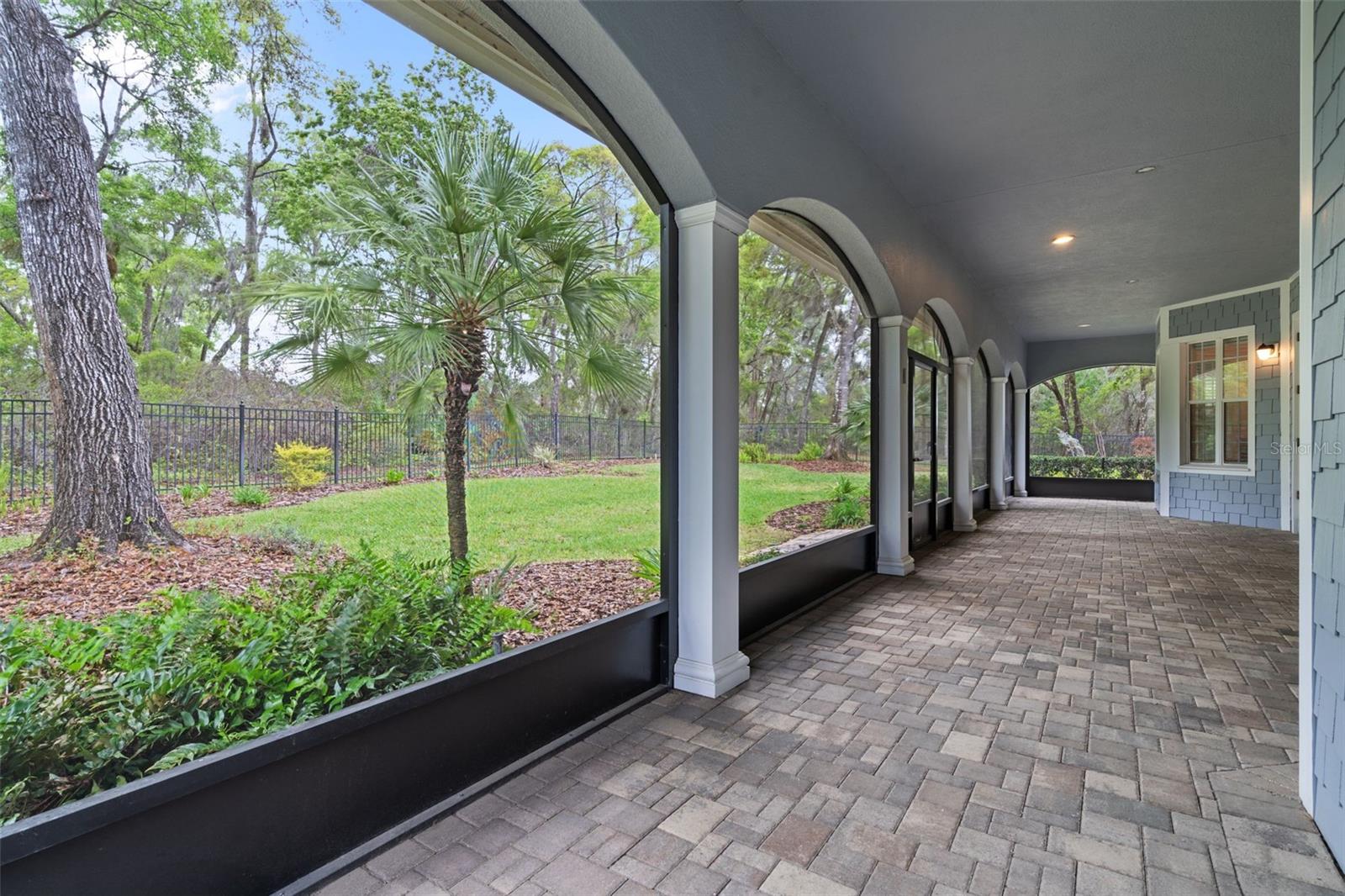 12X52 Rear Screened Lanai with Brick Pavers and Beautiful Architecture Overlooking Landscaped Backyard
