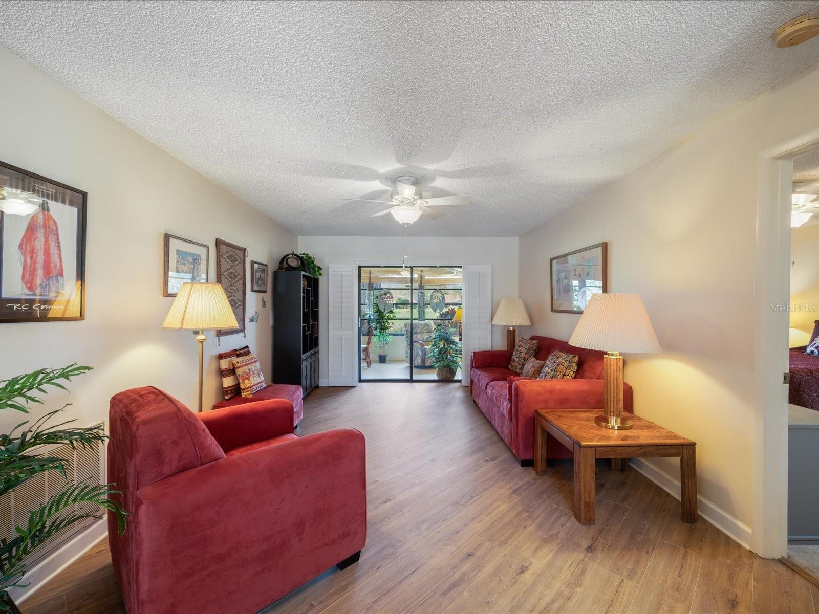 Living area looking out to the Florida room and golf course!