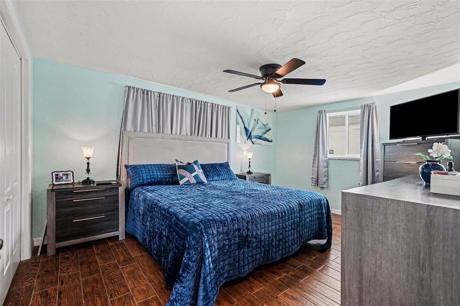 The large primary bedroom has plenty of space for a king size bed and end tables.