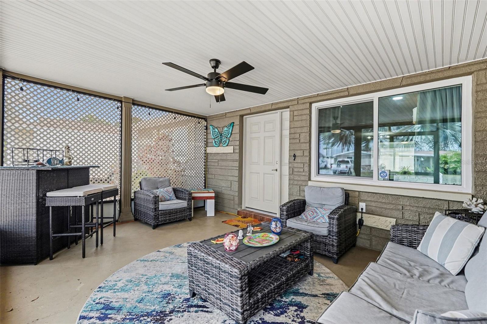 The cozy screened front porch is perfect for relaxing at the end of a busy day.