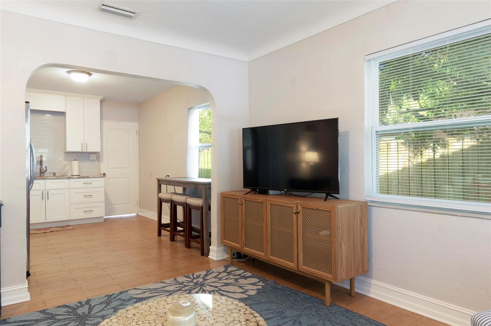 Architectural archway connects the kitchen and living room