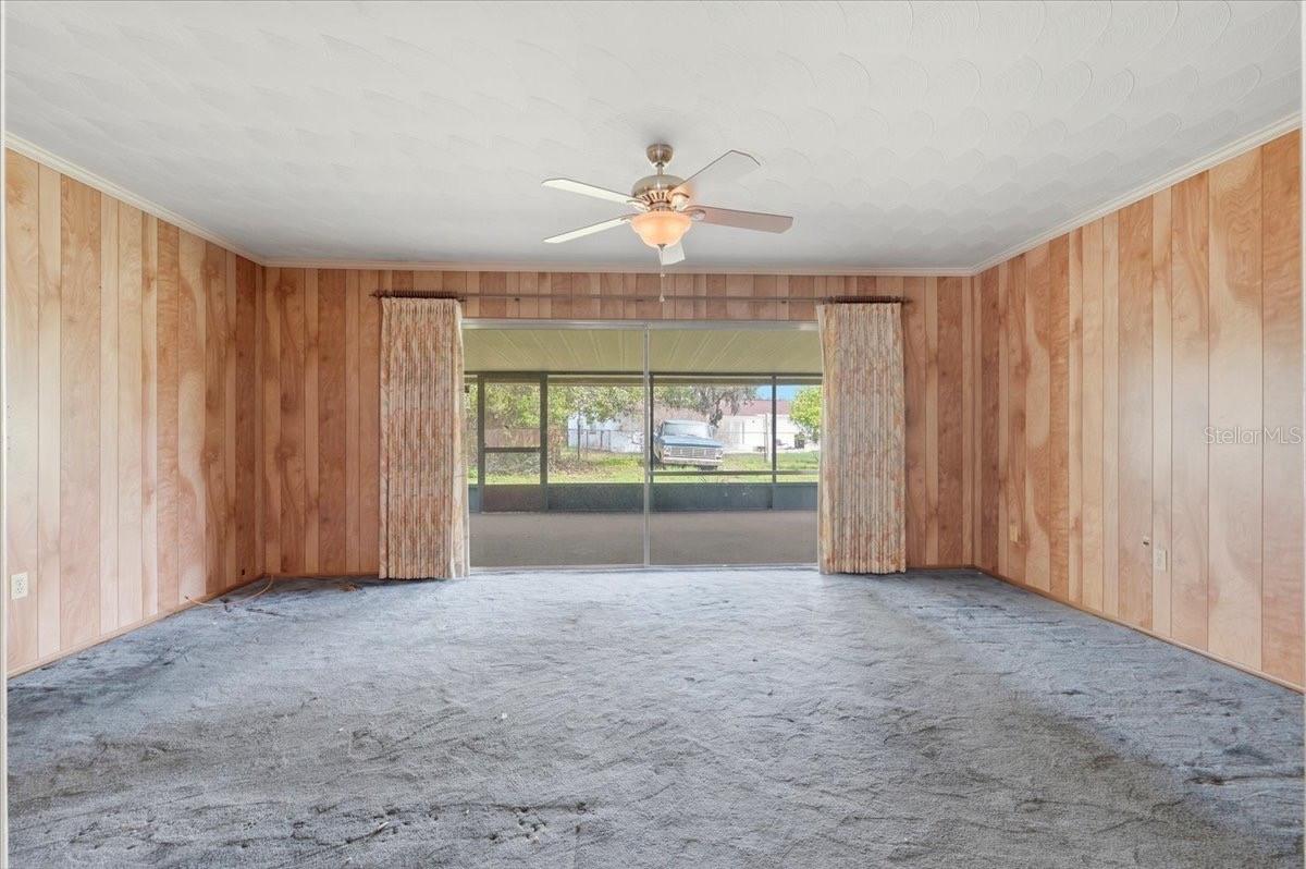 spacious family room with sliders leading to scr patio