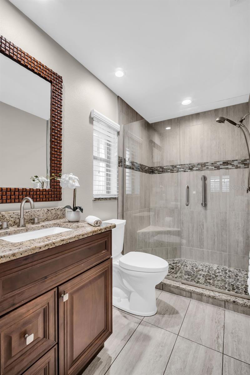 Beautifully updated en-suite with a walk-in shower, recessed lighting, and newer vanity with stone countertops~