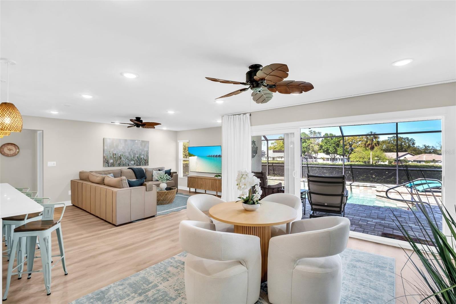 Oversized hurricane-impact sliders fully open to allow the true indoor/outdoor Florida living everyone dreams of~