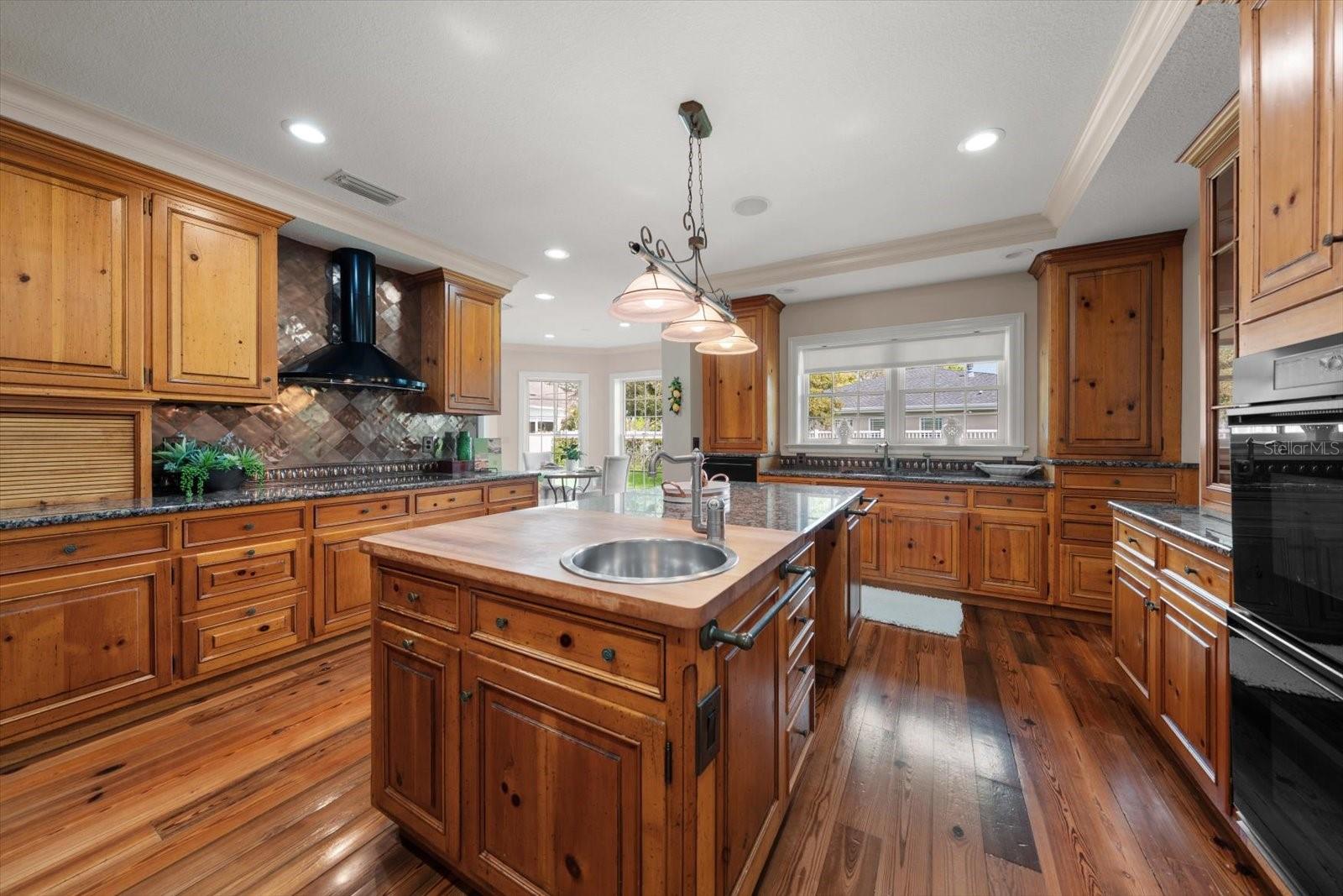 Pine wood flooring and attractive custom cabinetry, this is a kitchen that defines the "heart of the home".
